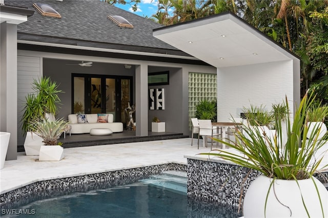 rear view of house featuring a patio area and an outdoor living space