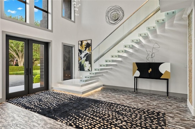 foyer with french doors and a high ceiling