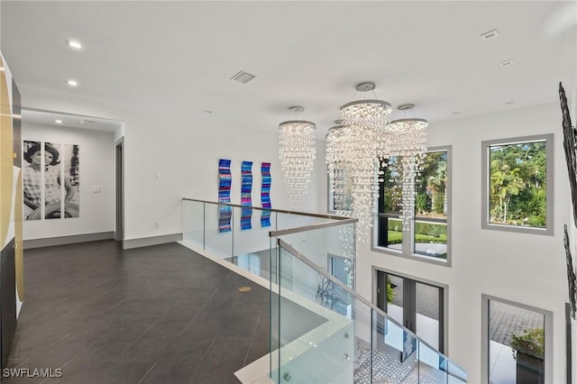 hallway with an inviting chandelier