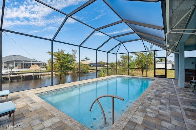 view of pool with a lanai, a water view, and a patio