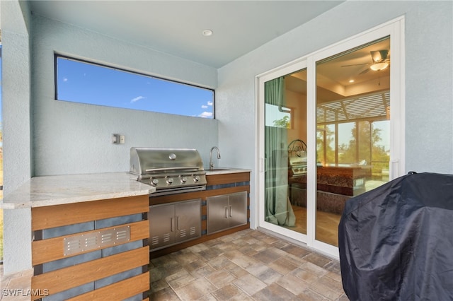 view of patio with sink, a grill, and exterior kitchen