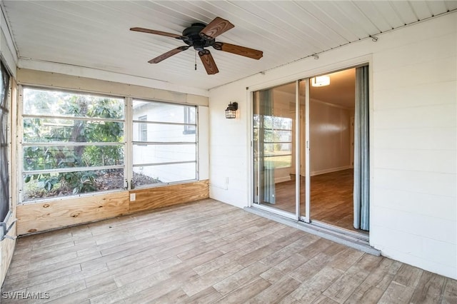 unfurnished sunroom with a wealth of natural light, ceiling fan, and wooden ceiling