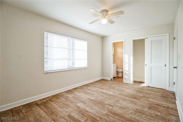 unfurnished bedroom with connected bathroom, ceiling fan, a closet, and light hardwood / wood-style floors