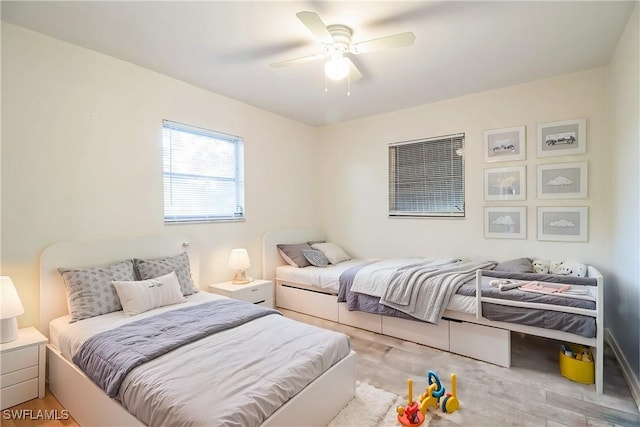 bedroom with light wood-type flooring and ceiling fan