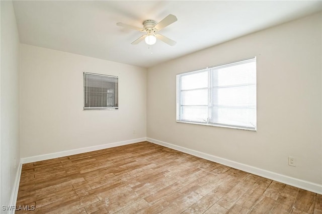 empty room featuring ceiling fan and light hardwood / wood-style floors