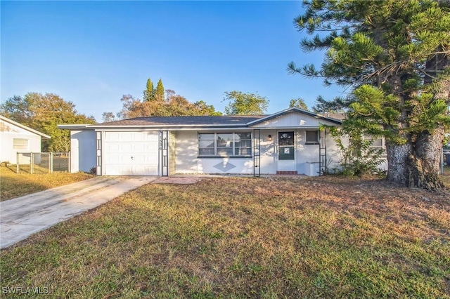 ranch-style house with a garage and a front yard