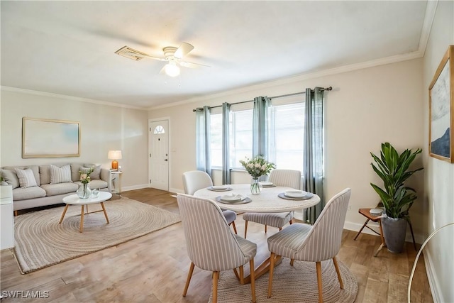 dining room featuring crown molding, ceiling fan, and light wood-type flooring