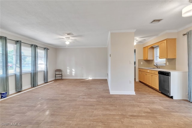 interior space with sink, dishwasher, crown molding, and light brown cabinets