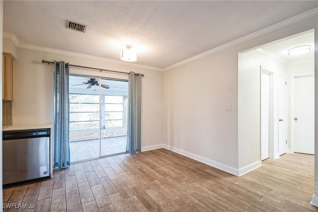 unfurnished dining area featuring ornamental molding, a textured ceiling, and light wood-type flooring