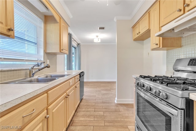 kitchen with light brown cabinets, sink, backsplash, and appliances with stainless steel finishes