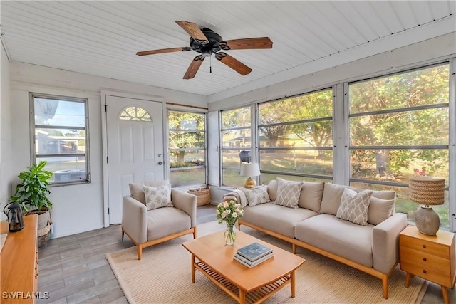 sunroom / solarium featuring wood ceiling, a wealth of natural light, and ceiling fan