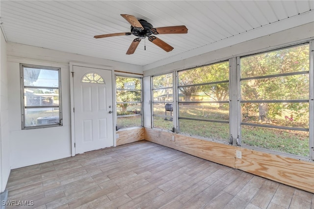 unfurnished sunroom with ceiling fan and wood ceiling