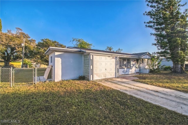 view of front of property with a garage and a front lawn