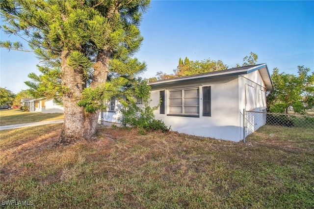 view of property exterior featuring a lawn