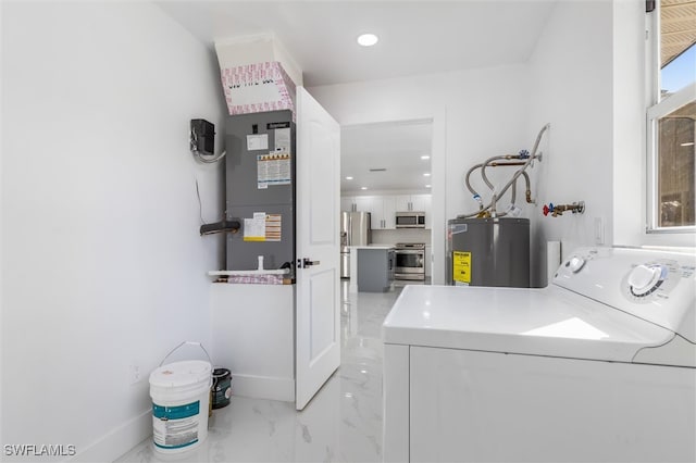 laundry room featuring washer / clothes dryer and water heater