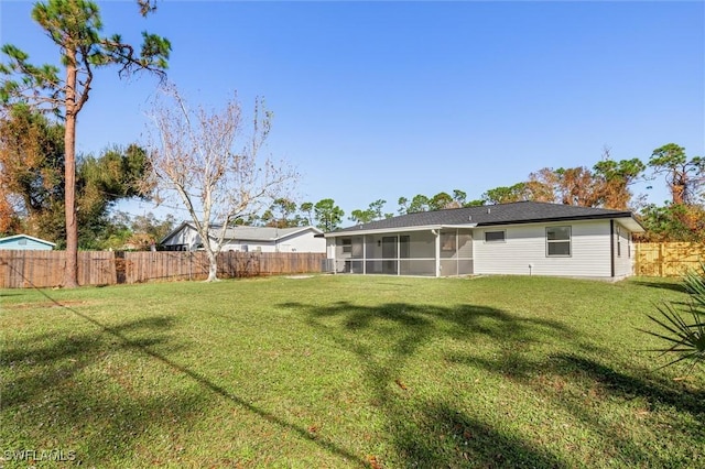 18289 Eblis Ave, Port Charlotte, FL 33948 - rear view of property featuring a fenced backyard, a yard, and a sunroom