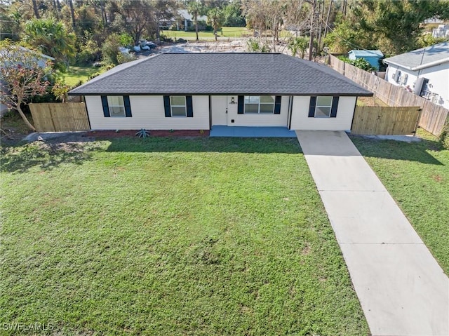 18289 Eblis Ave, Port Charlotte, FL 33948 - ranch-style house featuring fence, roof with shingles, and a front lawn