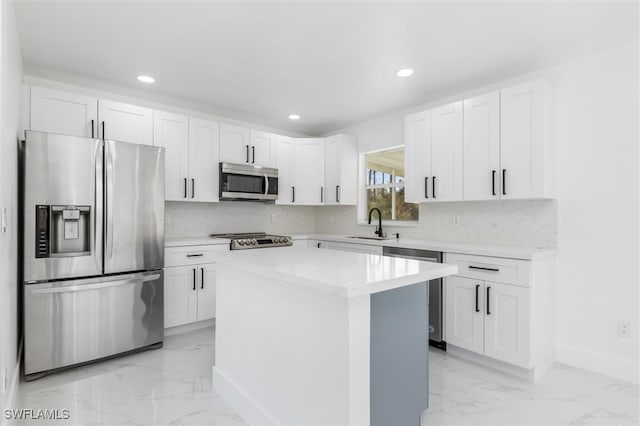 kitchen featuring a center island, white cabinetry, stainless steel appliances, and sink