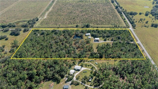 birds eye view of property with a rural view