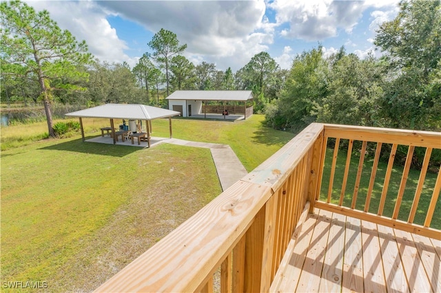 wooden deck with a yard and a patio area