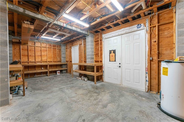 basement featuring water heater and a workshop area