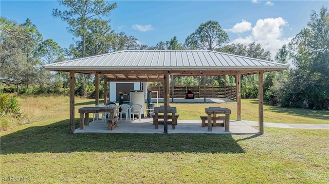 surrounding community featuring a gazebo, a patio area, and a yard