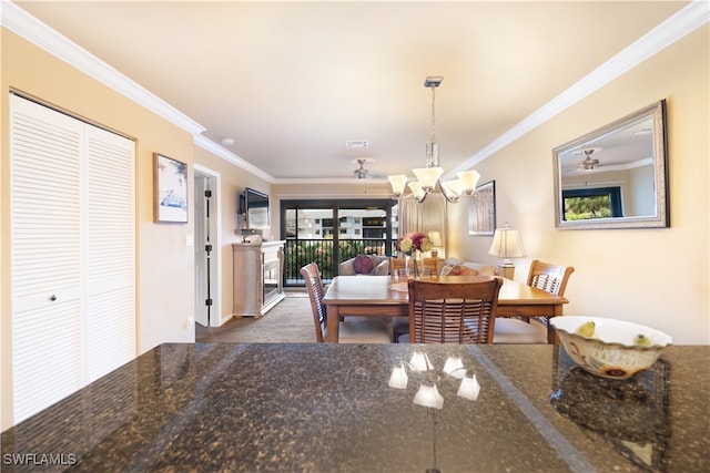 carpeted dining room featuring ornamental molding, ceiling fan with notable chandelier, and a wealth of natural light