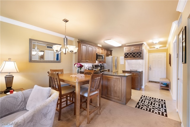 dining area featuring a chandelier and crown molding