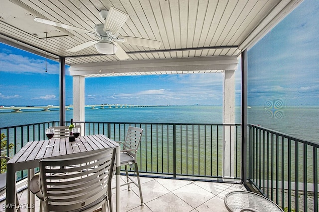 balcony featuring a water view and ceiling fan