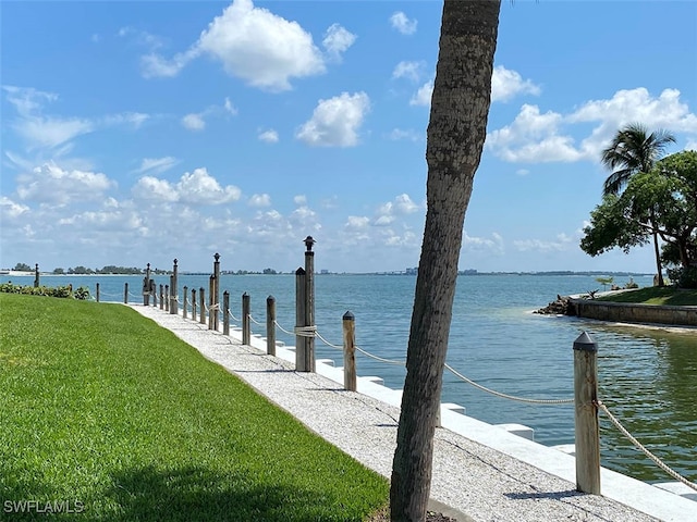 view of dock featuring a water view and a lawn