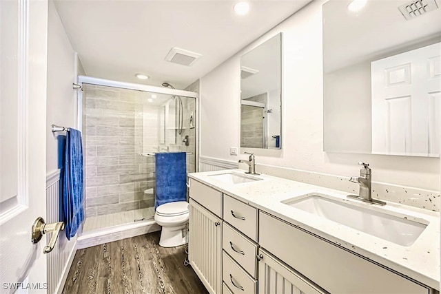 bathroom featuring toilet, walk in shower, vanity, and wood-type flooring