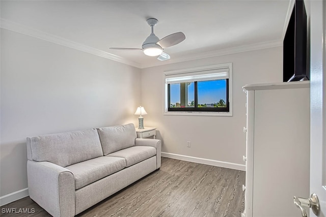 living room featuring ornamental molding, hardwood / wood-style flooring, and ceiling fan