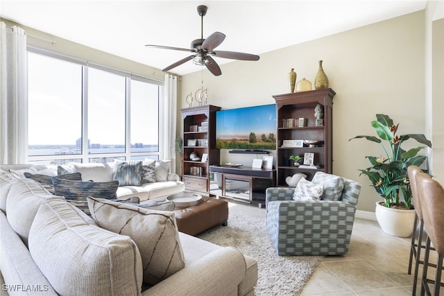 living room featuring light tile patterned floors and ceiling fan