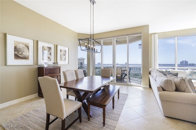 tiled dining area featuring a notable chandelier