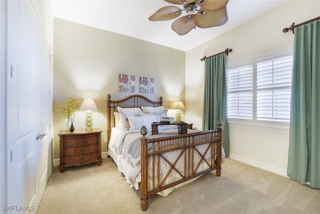 bedroom featuring light carpet and ceiling fan