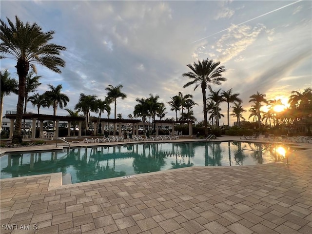 pool at dusk with a patio