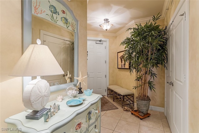 tiled foyer featuring ornamental molding