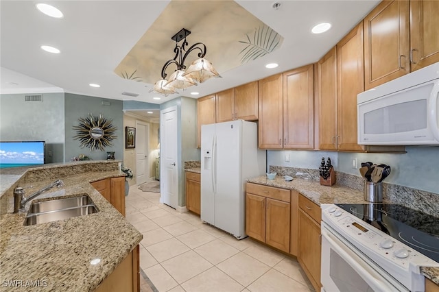 kitchen with light stone countertops, sink, pendant lighting, and white appliances