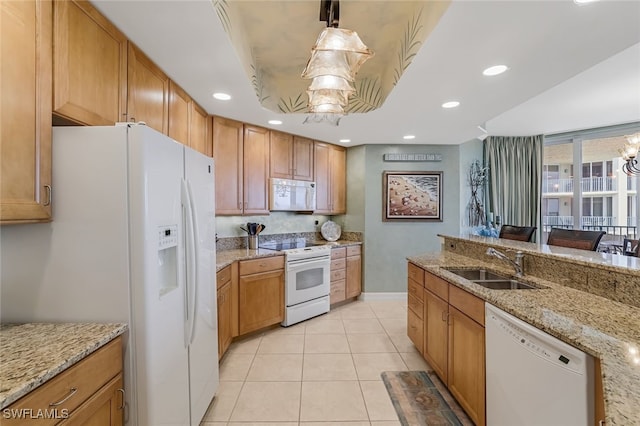 kitchen featuring light stone countertops, white appliances, sink, pendant lighting, and light tile patterned flooring