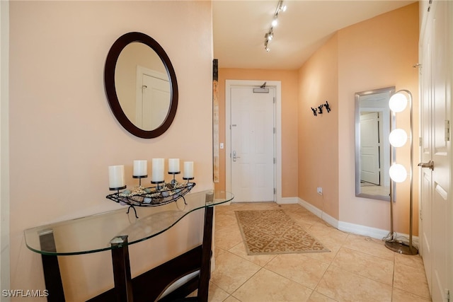 foyer entrance with light tile patterned flooring