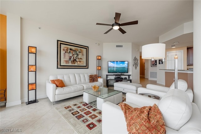 living room featuring light tile patterned floors and ceiling fan