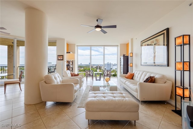 living room featuring ceiling fan, light tile patterned floors, and a wall of windows