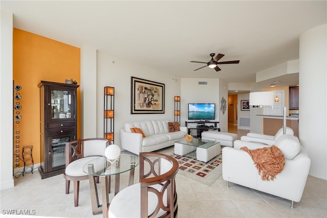 tiled living room with ceiling fan