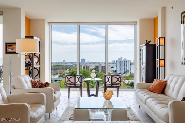 living room with light tile patterned flooring and a wall of windows