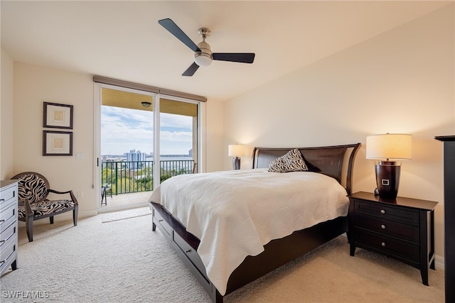 carpeted bedroom featuring ceiling fan, a wall of windows, and access to outside