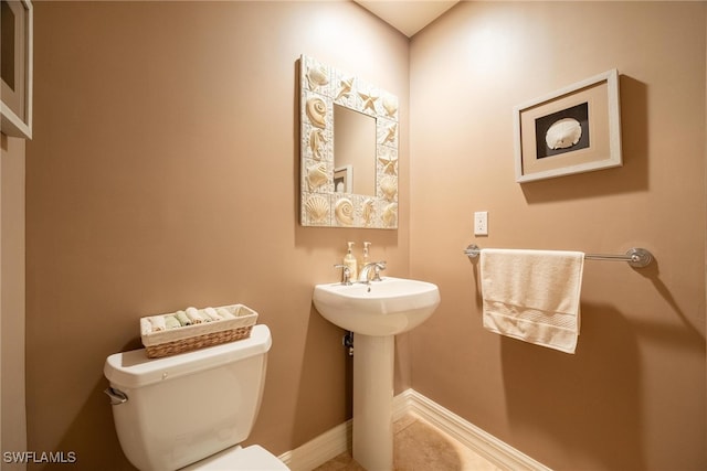 bathroom featuring tile patterned flooring and toilet