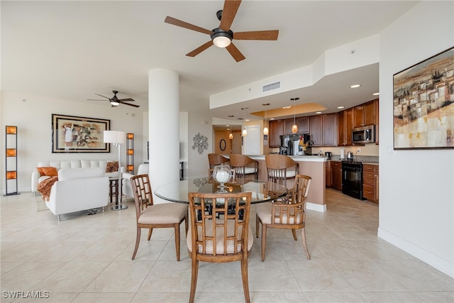 tiled dining area with ceiling fan