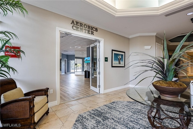 hall with light hardwood / wood-style floors and ornamental molding