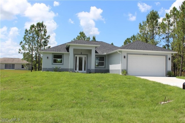 view of front of home with a front lawn and a garage