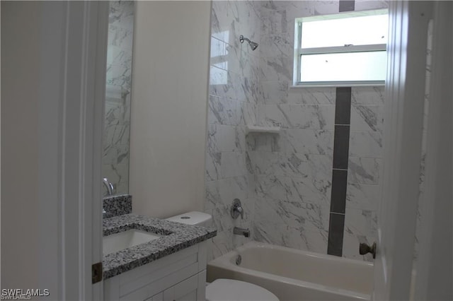 full bathroom with toilet, tiled shower / bath, and vanity